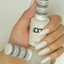 Hands wearing DND Gel 443 Twinkle Little Star