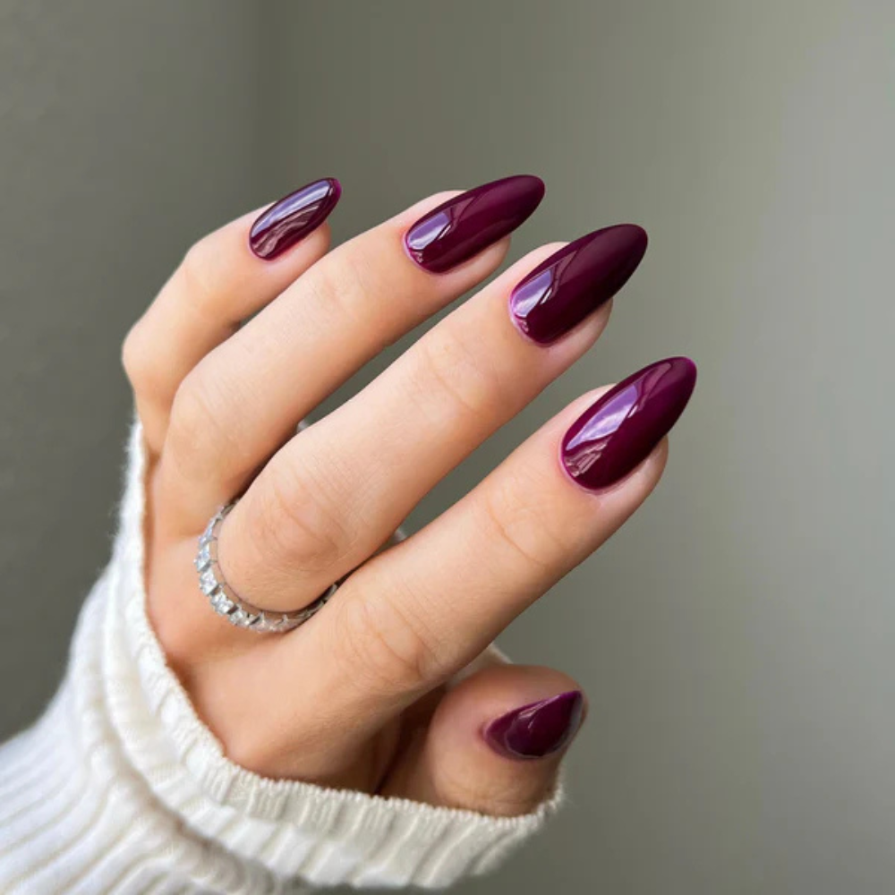 Hands wearing DND Gel 455 Plum Passion
