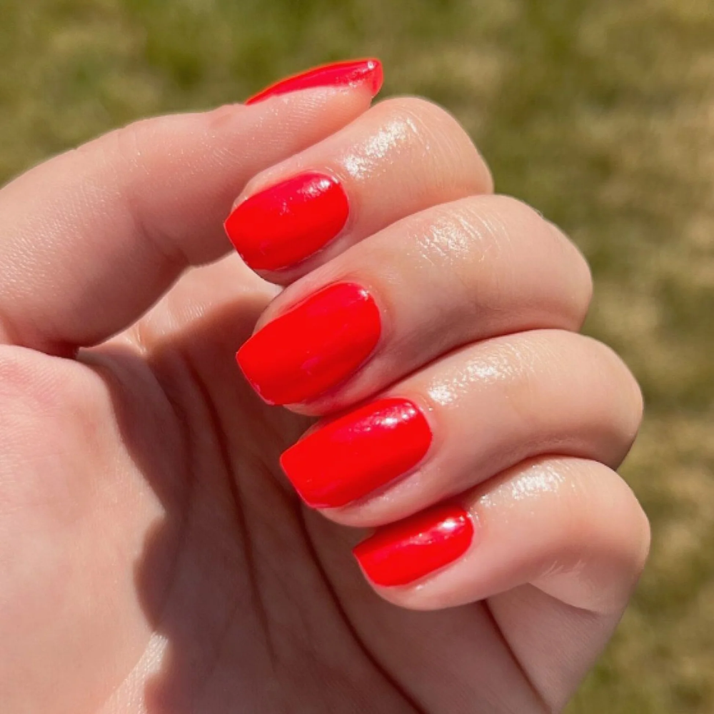 hands wearing DND Gel Polish - 474 Striking Red
