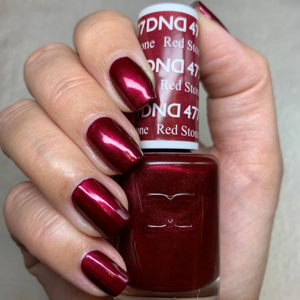 hands wearing DND Gel Polish 477 Red Stone