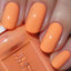 hands wearing color swatch of DND Gel Polish 502 Soft Orange
