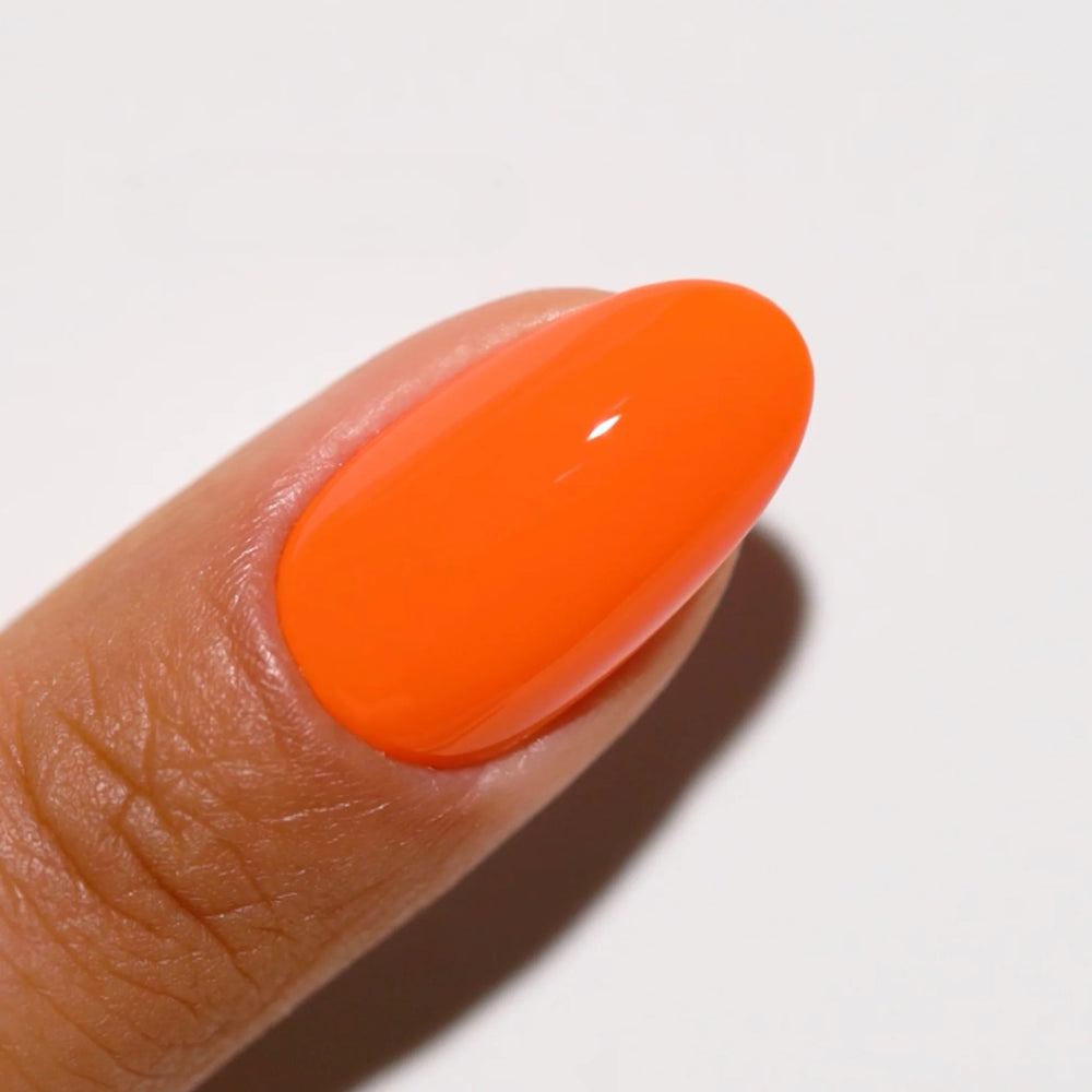 finger wearing DND Gel Polish 713 Orange Sherbet