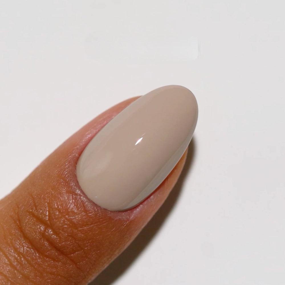finger wearing DND Gel Polish - 983 Slinky Taupe