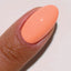 hands wearing 186 Peach Mimosa Gel & Polish Diva Duo by DND