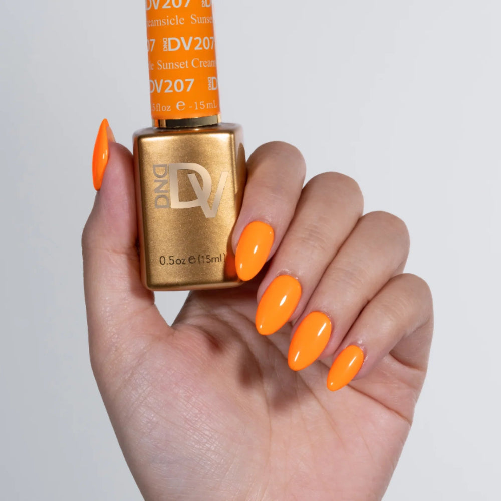 hand wearing 207 Sunset Creamsicle Gel & Polish Diva Duo by DND