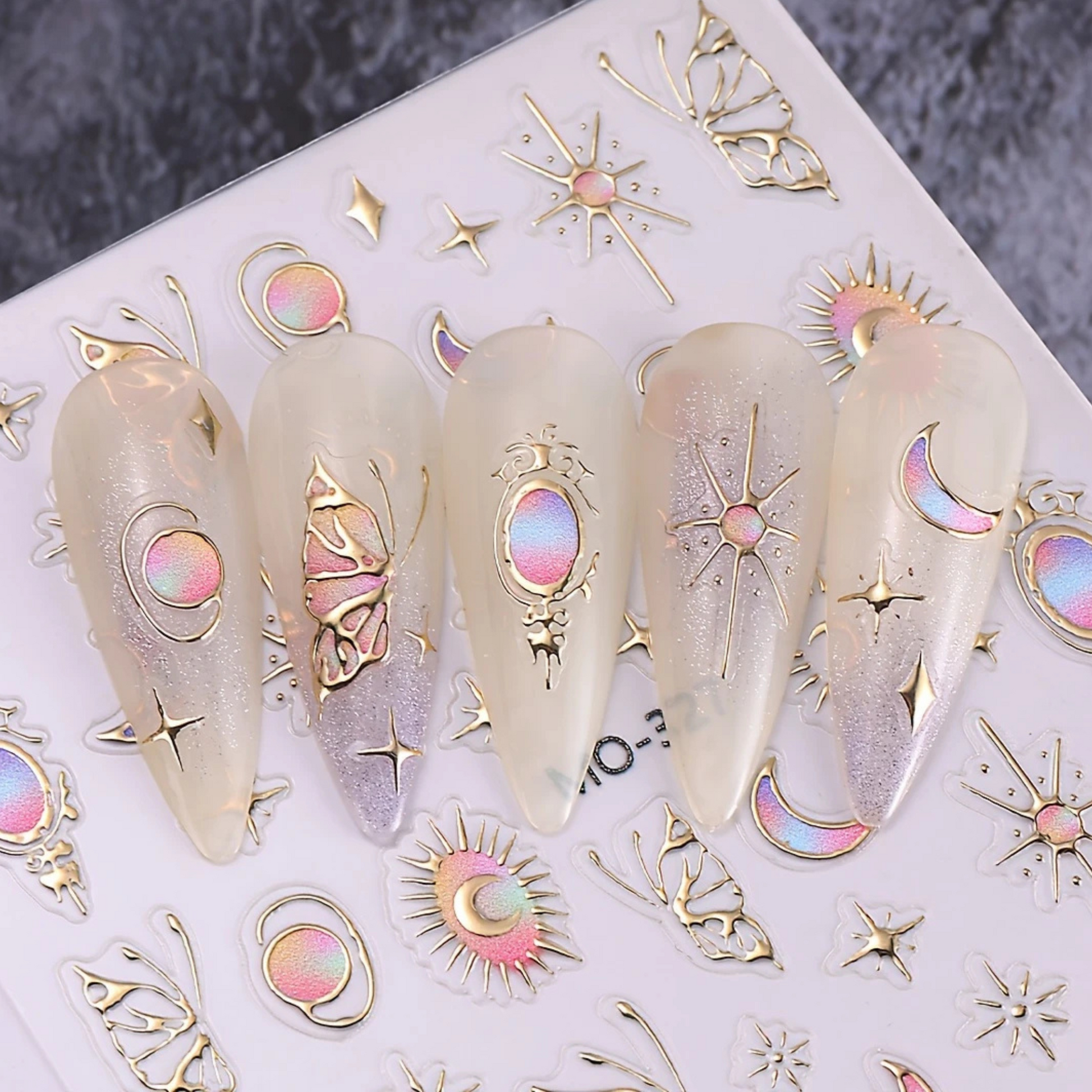 Decorative nail art stickers with celestial designs on a white surface.