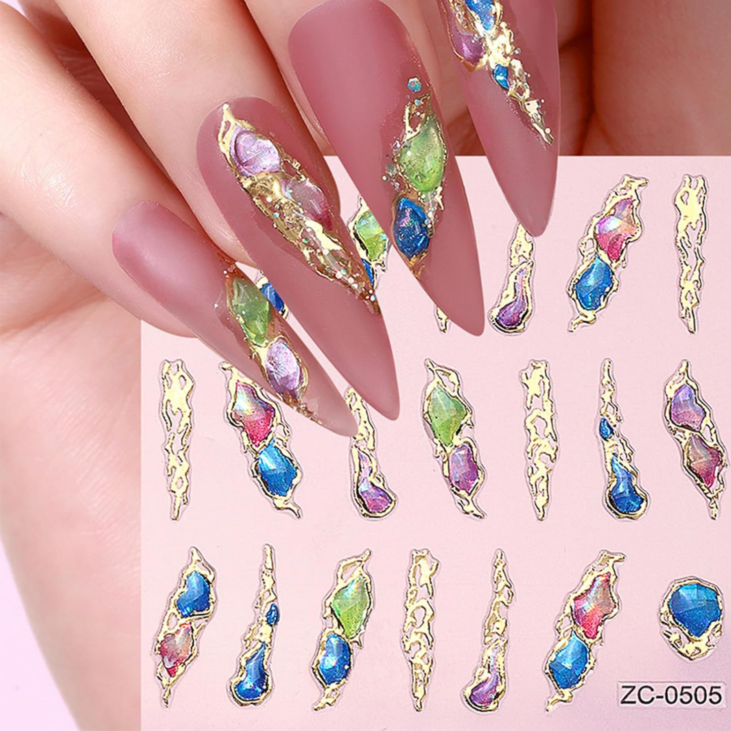 Nail art stickers with colorful gemstones on a pink background
