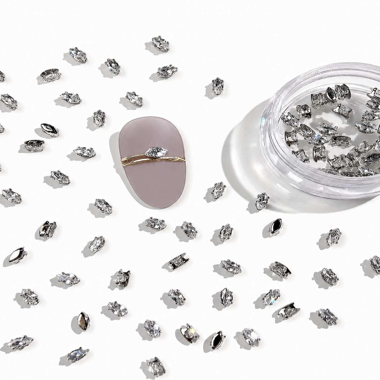Mixed-shape clear nail crystals with silver frames for luxury nail art and professional manicures.
