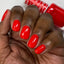 hands wearing 430 Ferrari Red Gel Polish by DND