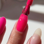 finger wearing DND Gel Polish 557 Hot Raspberry