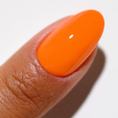 Finger wearing 2540 Orange Soda Gel & Polish Duo by DND DC