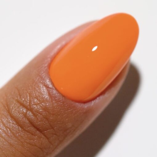 Finger wearing 2540 Orange Soda Gel & Polish Duo by DND DC