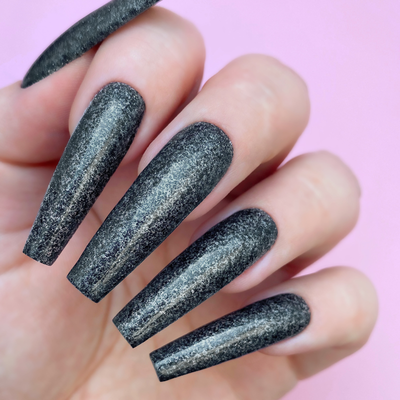 Hands wearing D5086 Little Black Dress All-in-One Powder by Kiara Sky